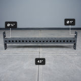 The Bells of Steel Crossmember For Converter Bench - 43" is a black metal bar with evenly spaced 5/8" and 1" holes, shown on a gray floor—perfect for rack setups or converter bench projects.