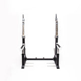 The Bells of Steel StrongArm Combo Rack is a black adjustable squat stand and bench press rack with metal supports, featuring "StrongArm" labels on the vertical bars, set against a plain white background.