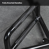 Close-up of a Bells of Steel Open Trap Bar / Hex Bar with fully knurled handles, resting on a gray textured floor. The text "Fully Knurled Handles" appears at the top.