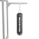 A black Heavy Bag Set from Bells of Steel hangs by chains from a metal frame resembling a power rack, set against a white background.