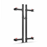 The Roc Foldable 2 Post Cage Builder by Bells of Steel is a black metal wall-mounted squat rack with adjustable arms and red hooks. It features modular components and multiple holes (3" x 3", ⅝") for easy customization, perfect for any home gym setup against a white background.