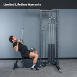 A man uses the Bells of Steel Lat Pulldown Low Row Machine with weight stack and pulleys in a gym, performing a lat pulldown. Text at the top reads "Limited Lifetime Warranty.