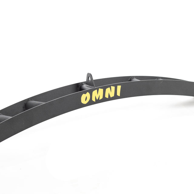 The Omni Bar by Bells of Steel is a black, slightly curved metallic beam with "OMNI" in yellow centered on a white background. A small knurled hook protrudes elegantly at the top.