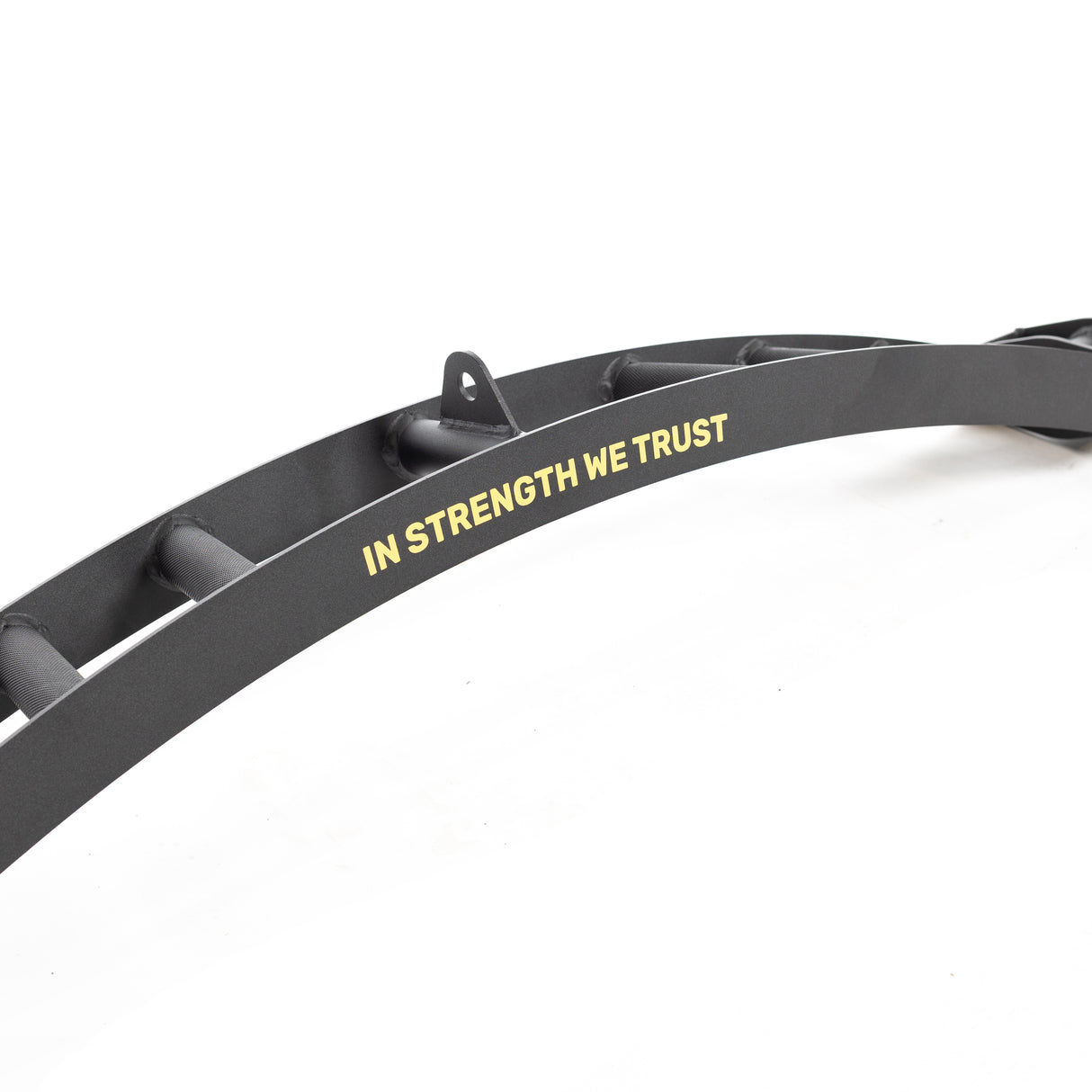 A close-up of the Bells of Steel Omni Bar shows a curved black metal beam with "IN STRENGTH WE TRUST" in yellow, featuring evenly spaced holes, a top bracket, and intricate knurling for a firm grip during intense workouts.