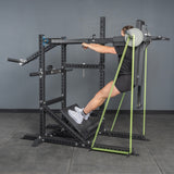A person in athletic clothes uses the Bells of Steel Pandemonium Squat—3-in-1 Pendulum Squat, Calf Press, and Viking Press Machine—standing on its angled platform with handles, making it ideal for any home gym setup.