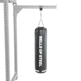 A black Bells of Steel Utility Shackle Rack Attachment hangs from a metal frame by chains against a white background, making it an ideal power rack accessory for those seeking a versatile home gym attachment.