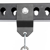 Close-up of the Bells of Steel Utility Shackle Rack Attachment, securely bolted to a perforated horizontal metal beam, with a hook suspended from the bracket—an excellent power rack accessory for any home gym attachment setup.