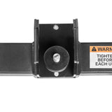 Close-up of the Bells of Steel Shoulder Boulder/Chest Fly Attachment, showing its black metal bracket with a circular center and bolts. A partial warning label is visible on the device's right side.