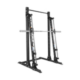 The Bells of Steel Smith Machine - Hydra (3" x 3", ⅝" holes) is a black metal squat stand with a fixed horizontal barbell on guided rails, adjustable safety stops, pull-up bar, and a robust 600lb weight capacity for strength training.