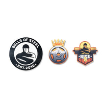 Upgrade your Bells of Steel sticker collection with three enamel pins—a muscular figure with "EST. 2010," a crowned barbell plate, and a strongman with "Rise & Grind"—all perfect complements to the Die-Cut Sticker Upgrade / Sticker Pack.