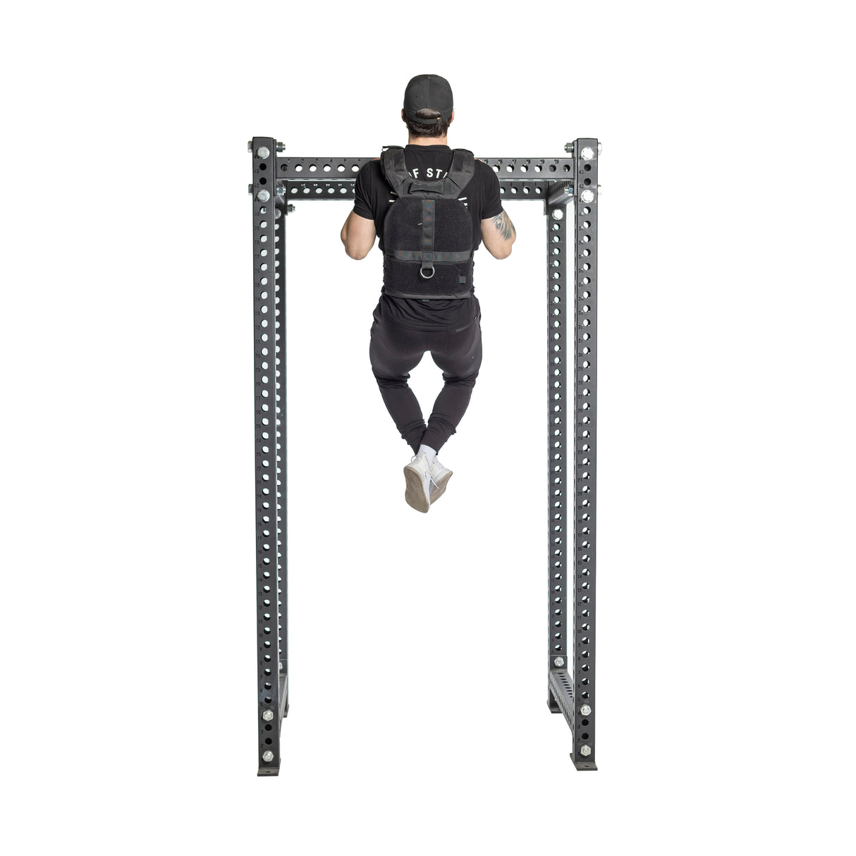 Wearing a black cap and Bells of Steel Canada's Weighted Vest and Plates, the individual demonstrates strength and endurance by performing a pull-up on a durable steel bar, with their back facing the camera against an isolated white background.