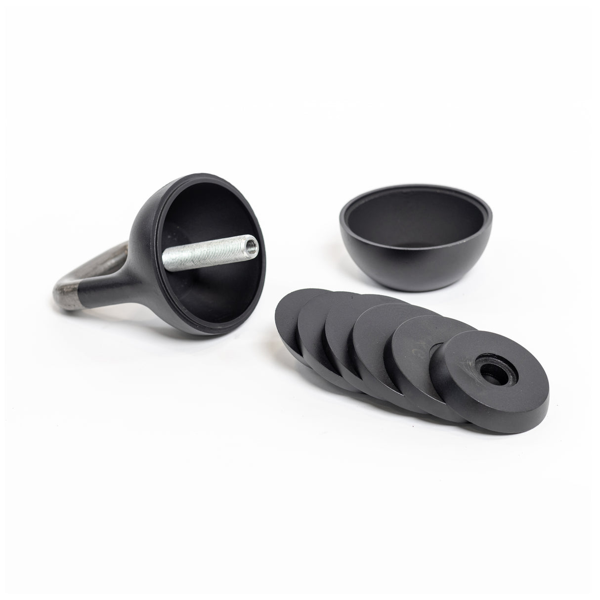 The Bells of Steel ring toss game features a sleek black design with a hook, cup, and rings mounted on a base. These components boast Wildman Athletica-inspired craftsmanship and a smooth finish, all set against a crisp white backdrop.